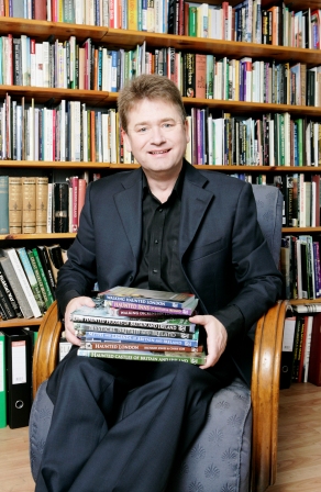 Dickens Tour Guide Richard Jones holding books.