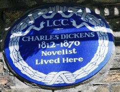 Blue plaque outside the Dickens House in London.