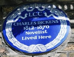 Blue plaque outside the Dickens House in London.